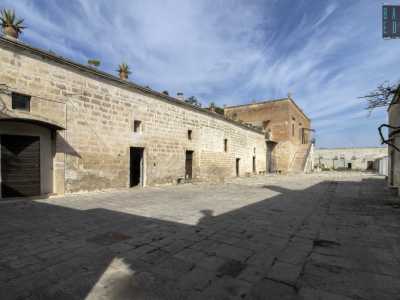 Usciamo dalla chiesetta e varchiamo ora il portone in legno della masseria che ci conduce in un vasto piazzale pavimentato con chianche...